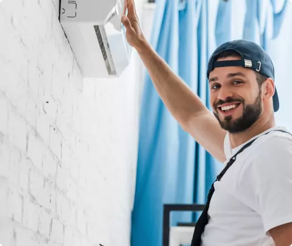 The Air duct Technician is holding the ac on picture.