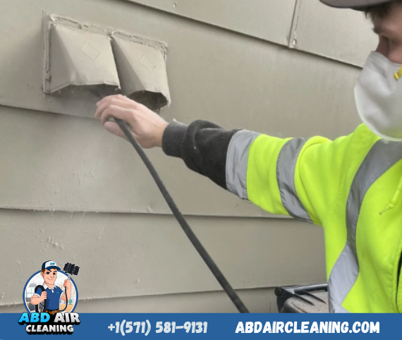 dryer vent cleaning service is being performed by a technician in fairfax va